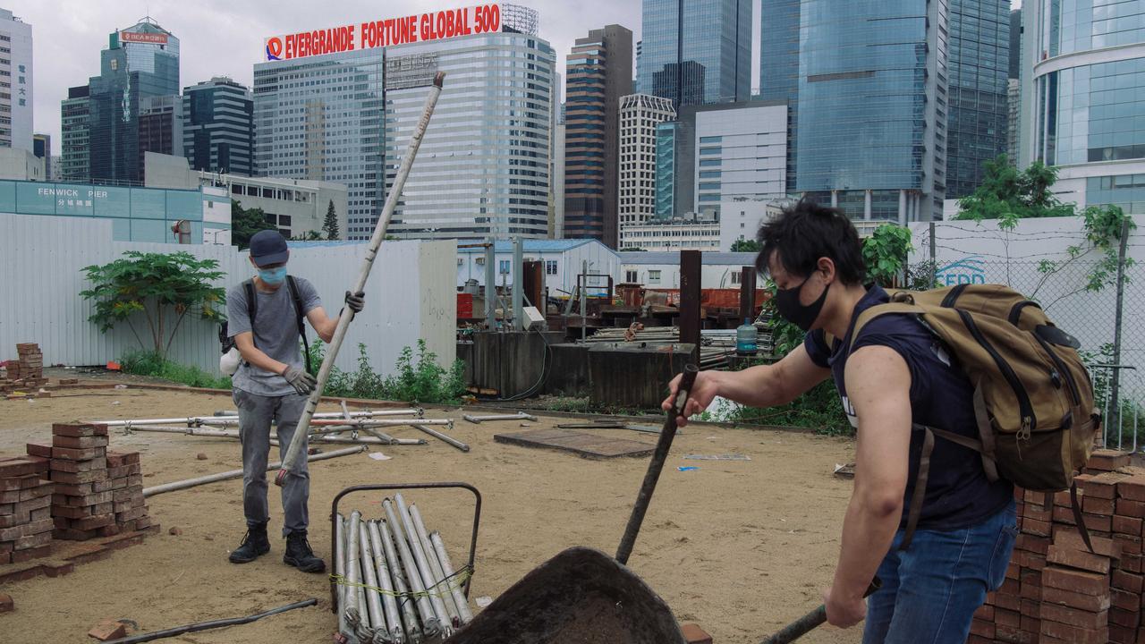 Protesters collect bricks and iron bars to use as roadblocks. Picture: Billy H.C. Kwok/Getty Images