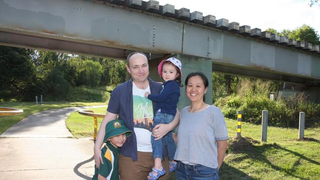 Algester residents Mallory Wuthrich and Mei-Ya Lin with their children Joshua, 5, and Madeleine, 2 at Col Bennett Park under the existing train track. Photo: Kristy Muir