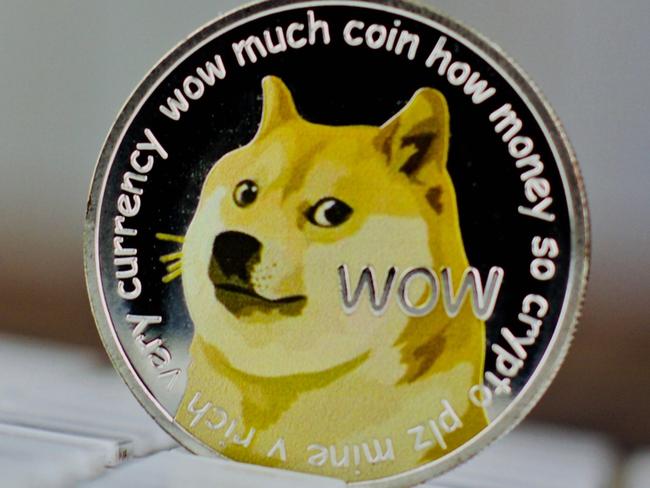 Digital currency physical metal dogecoin coin on white computer keyboaed.  Picture: istock