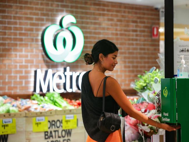 SYDNEY, AUSTRALIA - NewsWire Photos DECEMBER 29, 2020.A lady is seen sanitizing her hands prior to entering the Woolworths Metro supermarket at Bondi Beach on Campbell parade which is on the Covid-19 Alert list provided by the NSW Health, in Sydney Australia. Picture: NCA NewsWire / Gaye Gerard