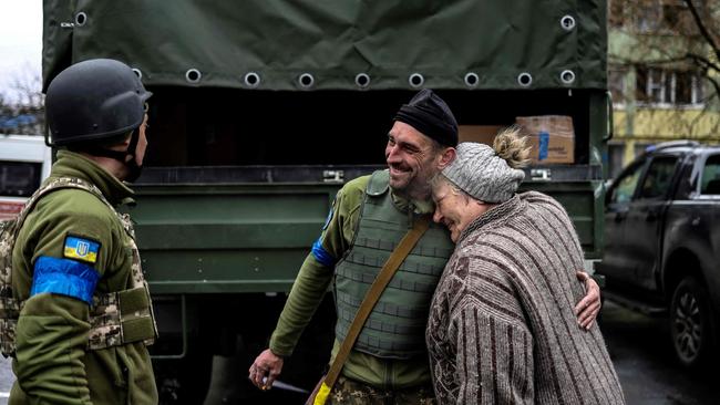 An woman embraces a Ukranian soldier in Bucha, northwest of Kyiv after Ukraine regained control of “the whole Kyiv region’’ after invading Russian forces retreated from some key towns near the Ukrainian capital.