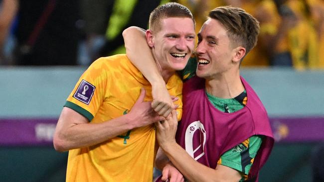 Wollongong’s Joel King (right) alongside Kiama’s Kye Rowles (left) after the Socceroos defeated Denmark in Qatar. (Photo by Alberto PIZZOLI / AFP)