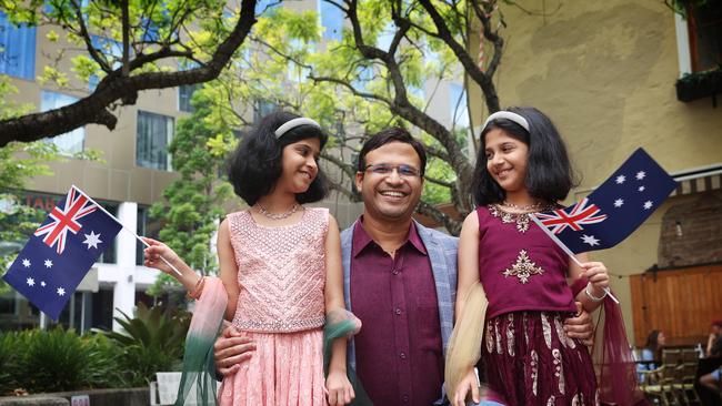 Ashutosh “Ash” Phatak with his twin daughters Anwesha and Sharveyi after becoming Australian citizens at the Parramatta citizenship ceremony. Picture: John Feder.