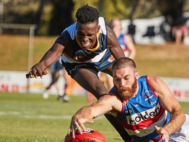 Adelaide's Aron Asfaha and Central's Isaya McKenzie go to the ground at Elizabeth Oval, in the match between the Crows and Bulldogs, Saturday, April 21, 2018. (AAP Image/MATT LOXTON)