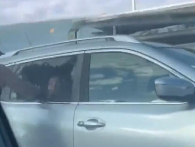 Shocking footage shows a man smashing through a car window and assaulting a mother who had a child in the back in a horrific road rage incident. Picture: 9News