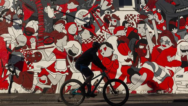 A cyclist rides past a wall mural in Melbourne’s inner-city Prahran on September 6.