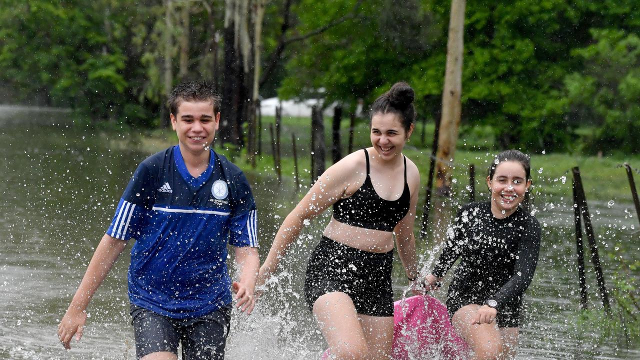 Wet weather in Townsville. Matty, 14, Lexie, 16, and Charlie Wendt, 11, enjoy the rain in Kelso. Picture: Evan Morgan