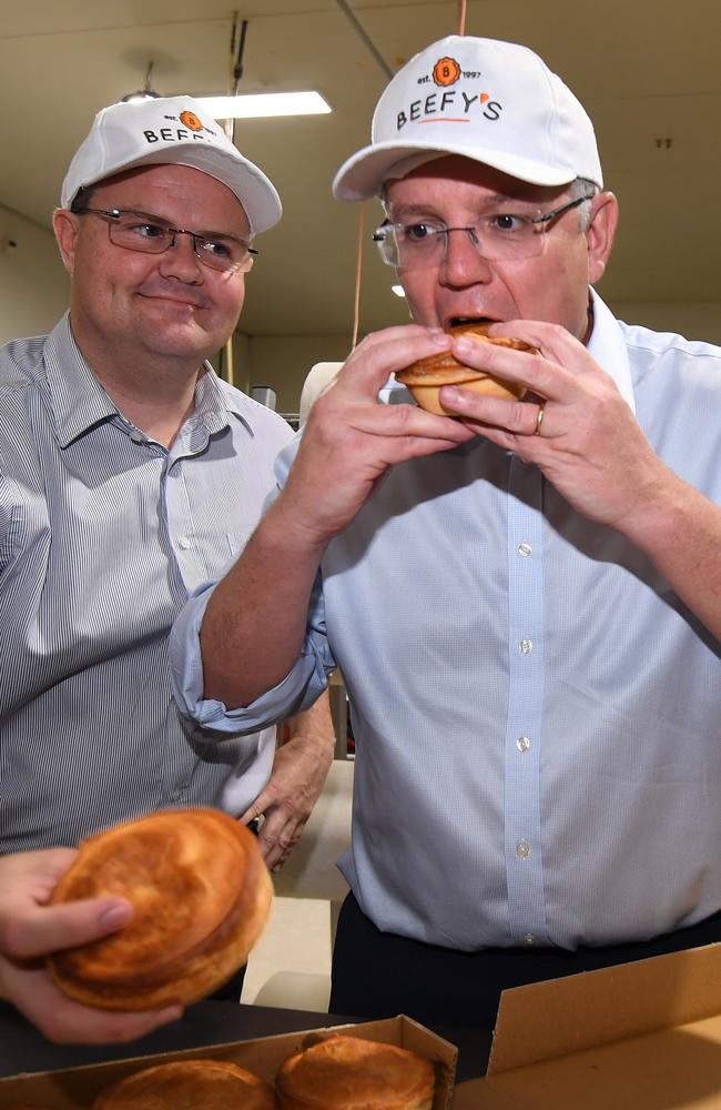 ScoMo, at Beefy’s Pies on the Sunshine Coast earlier today, is going out of his way to prove he’s a dinkie-di Aussie with a broad public appeal by eating meat pies, wearing baseball caps, sculling beers and posting chatty videos of himself on Twitter. Picture: Dan Peled/AAP