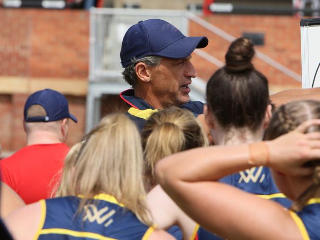 AFLW Crows and GWS play a trial game at Richmond Oval, SA. Coach Matthew Clarke talks to players during half time. (AAP/Emma Brasier) ADDITIONAL INFORMATION: Chelsea Randall and Erin Phillips on the sidelines. Coach Matthew Clarke and Team Assistant Coach Narelle Smith.