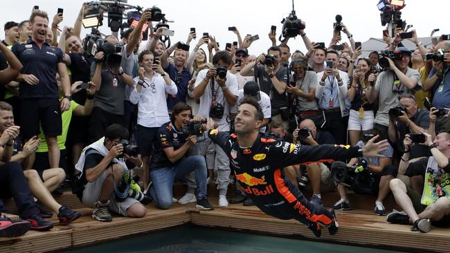 Red Bull driver Daniel Ricciardo dives into a pool.                        <a capiid="ad0be314b734ee86c025b51bffefe09d" class="capi-video">Dan Ricciardo hugs mum and dad after Monaco GP win</a>