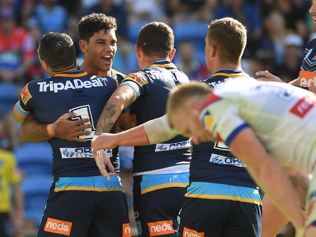 Brian Kelly  of the Titans (left)  reacts after scoring a try during the Round 6 NRL match between the Gold Coast Titans and the Newcastle Knights at CBUS Stadium on the Gold Coast, Sunday, April 21, 2019.  (AAP Image/Dave Hunt) NO ARCHIVING, EDITORIAL USE ONLY