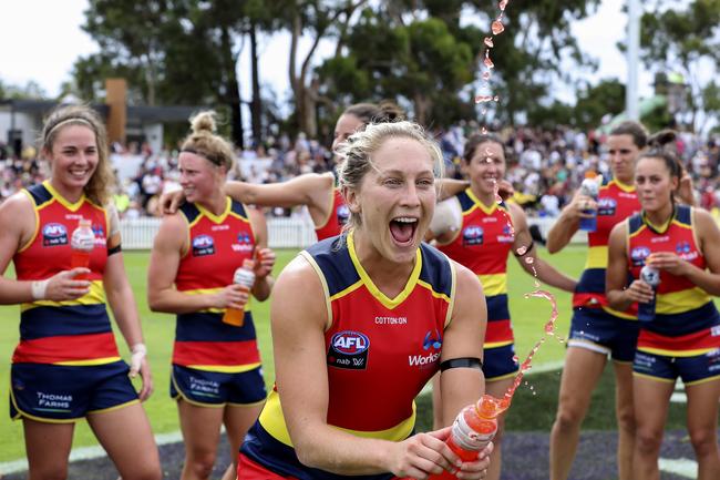 Adelaide’s Marijana Rajcic sprays Stevie-Lee Thomson with soft drink as she comes towards the huddle after the win against the Giants at Peter Motley Oval. Picture Sarah Reed.