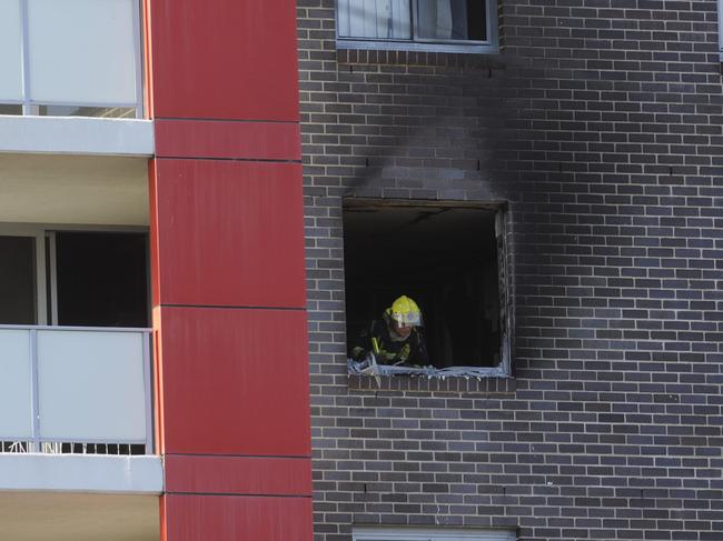 A firefighter at the window where the two women jumped at the Bankstown apartment block.