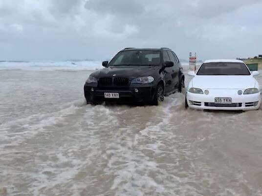 Large waves caused by Tropical Cyclone Oma have combined with king tides to create havoc on beachside suburbs on the Gold Coast. Water can be seen rushing over a carpark outside Currumbin Vikings Surf Life Saving Club in Currumbin. Footage: Adam Head.