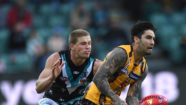 Chad Wingard of the Hawks (right) against his old team in Port Adelaide. Picture: AAP Image/Julian Smith