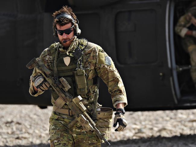 SAS Corporal Ben Roberts-Smith VC, MG, with the Australian Special Operations Task Group, leaves a UH-60 Blackhawk helicopter during preparation of the Shah Wali Kot offensive in Afghanistan, 06/2010. Roberts-Smith was later awarded the Victoria Cross during action in saving the lives of wounded comrades.