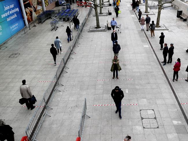 Shoppers queue at a supermarket in London. Picture: AP