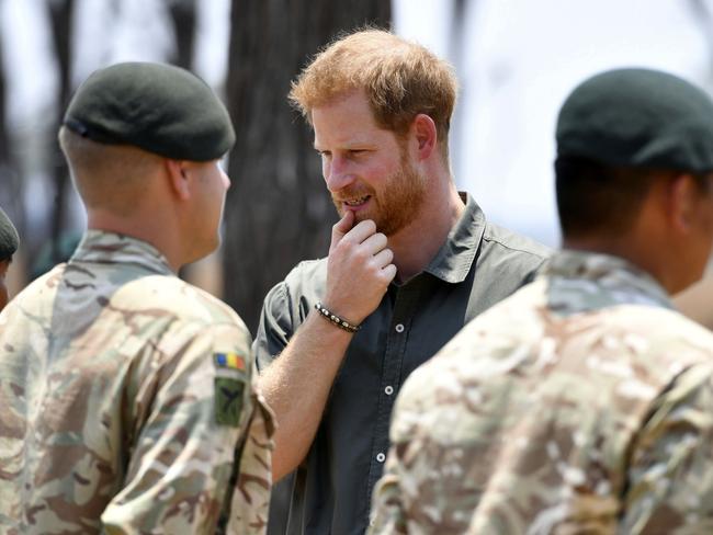 Prince Harry pays tribute to Guardsman Mathew Talbot of the Coldstream Guards, who lost his life in May on a joint anti-poaching patrol with local park rangers. Picture: Dominic Lipinski/Pool via AP