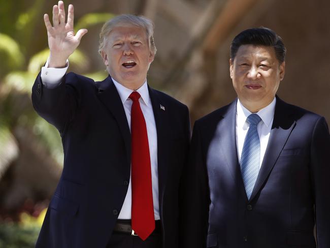 US President Donald Trump, left, wants Chinese President Xi Jinping to heavy North Korea, while Mr Xi has called for “restraint”. Picture: AP