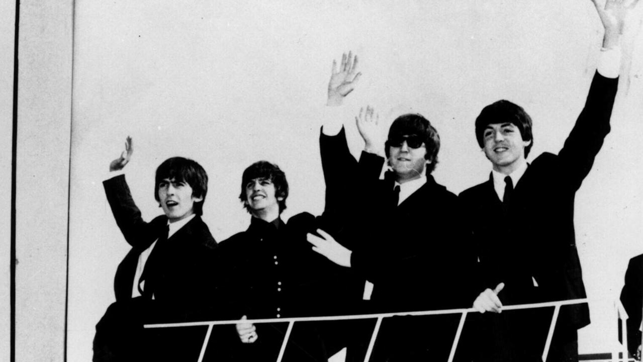 The Beatles greeting fans on their arrival in Sydney, 1964. They have performed at both the Palais and Festival Hall. Picture: Courtesy Glenn A Baker Archives.