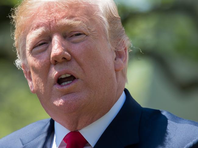 (FILES) In this file photo taken on May 03, 2018 US President Donald Trump speaks at the National Day of Prayer ceremony in the Rose Garden of the White House in Washington, DC. President Donald Trump on Thursday admitted he reimbursed his lawyer for a $130,000 payment to a porn star, ending months of White House denial. / AFP PHOTO / SAUL LOEB