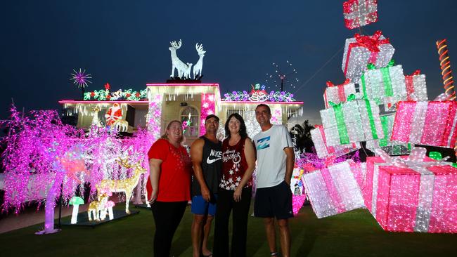 Residents Lisa Corcoran, Bill and Sandy Thistlethwaite with Matt Moore at his Christmas display on Forest-Oak Drive. Photo: David Clark