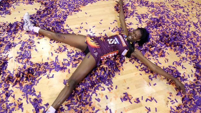 Romelda Aiken makes a snow angel after winning the ANZ Championship title with the Queensland Firebirds over New Zealand’s Northern Mystics in 2011. Pic: Peter Wallis