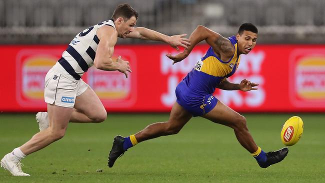 Geelong’s Patrick Dangerfield and former teammate Tim Kelly race for the ball