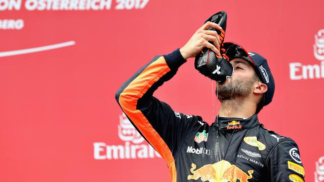 SPIELBERG, AUSTRIA - JULY 09: Daniel Ricciardo of Australia and Red Bull Racing celebrates finishing in third place on the podium during the Formula One Grand Prix of Austria at Red Bull Ring on July 9, 2017 in Spielberg, Austria. (Photo by Mark Thompson/Getty Images)