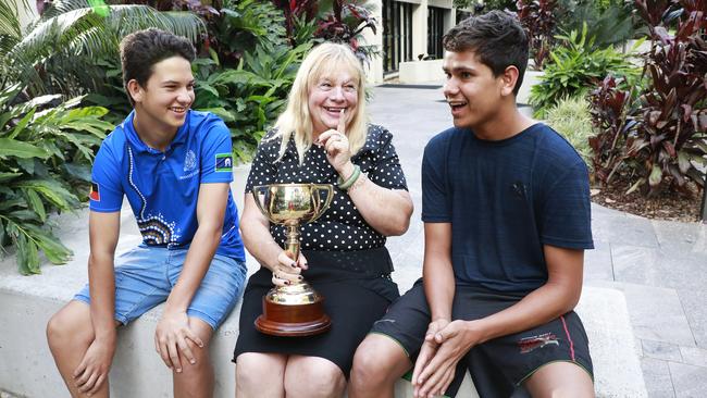 Teacher Wendy Green shows her Cup to boarders Jahdarl Rogers, 13, and Dylan James, 15, at St Joseph’s Nudgee College in Brisbane. Picture: Claudia Baxter