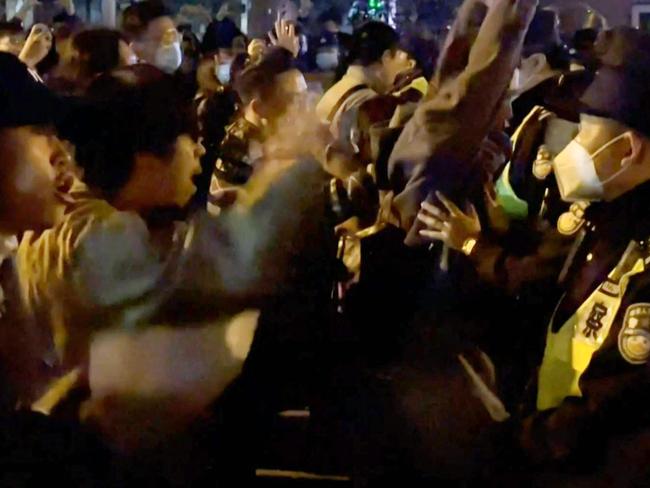 Angry crowds took to the streets in Shanghai, as public opposition to the government's hard line zero-Covid policy mounts. Picture: AFP.