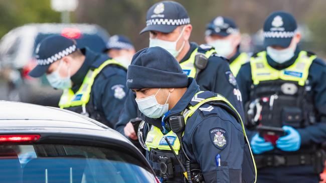 Police speak to a driver at the Albury-Wodonga border on Monday. Picture: Simon Dallinger