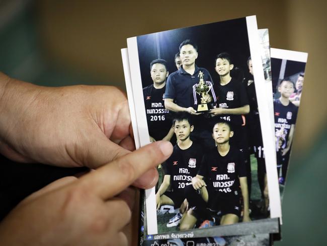 Banphot Konkum, father of Duangpetch Promthep, shows a picture of his son with his football team. Picture: AP/Vincent Thian