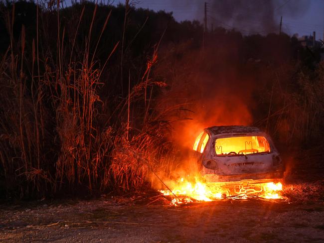 A car burns following clashes between Syria's new authorities and supporters of deposed president Bashar al-Assad near the town of Jableh in the coastal province of Latakia on March 10, 2025. The authorities on March 10 ended their sweeping "military operation" against security threats and "regime remnants" in Latakia and Tartus provinces on the Mediterranean coast, defence ministry spokesman Hassan Abdul Ghani said in a statement. (Photo by Omar HAJ KADOUR / AFP)