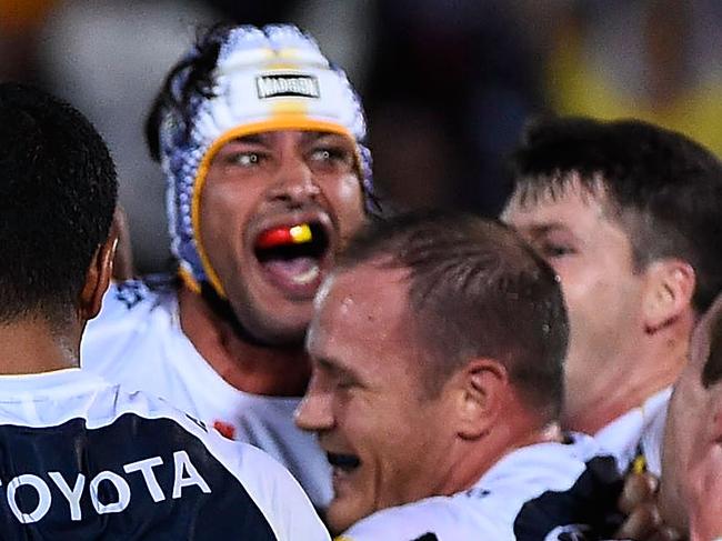 TOWNSVILLE, AUSTRALIA - MARCH 30: Johnathan Thurston of the Cowboys celebrates with team mates after kicking the winning field goal during the round four NRL match between the North Queensland Cowboys and the Melbourne Storm at 1300SMILES Stadium on March 30, 2015 in Townsville, Australia. (Photo by Ian Hitchcock/Getty Images)