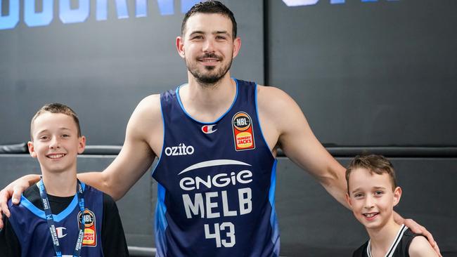 Melbourne United captain Chris Goulding with members Archer and Oscar Mclauchlan. Picture: Melbourne United Media