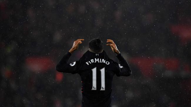 Liverpool's Brazilian midfielder Roberto Firmino reacts at the final whistle.