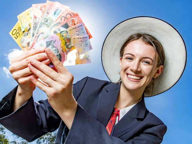 Springfield Anglican College Year 11 student Abigail Lowden with a fistful of dollars. Picture: Richard Walker