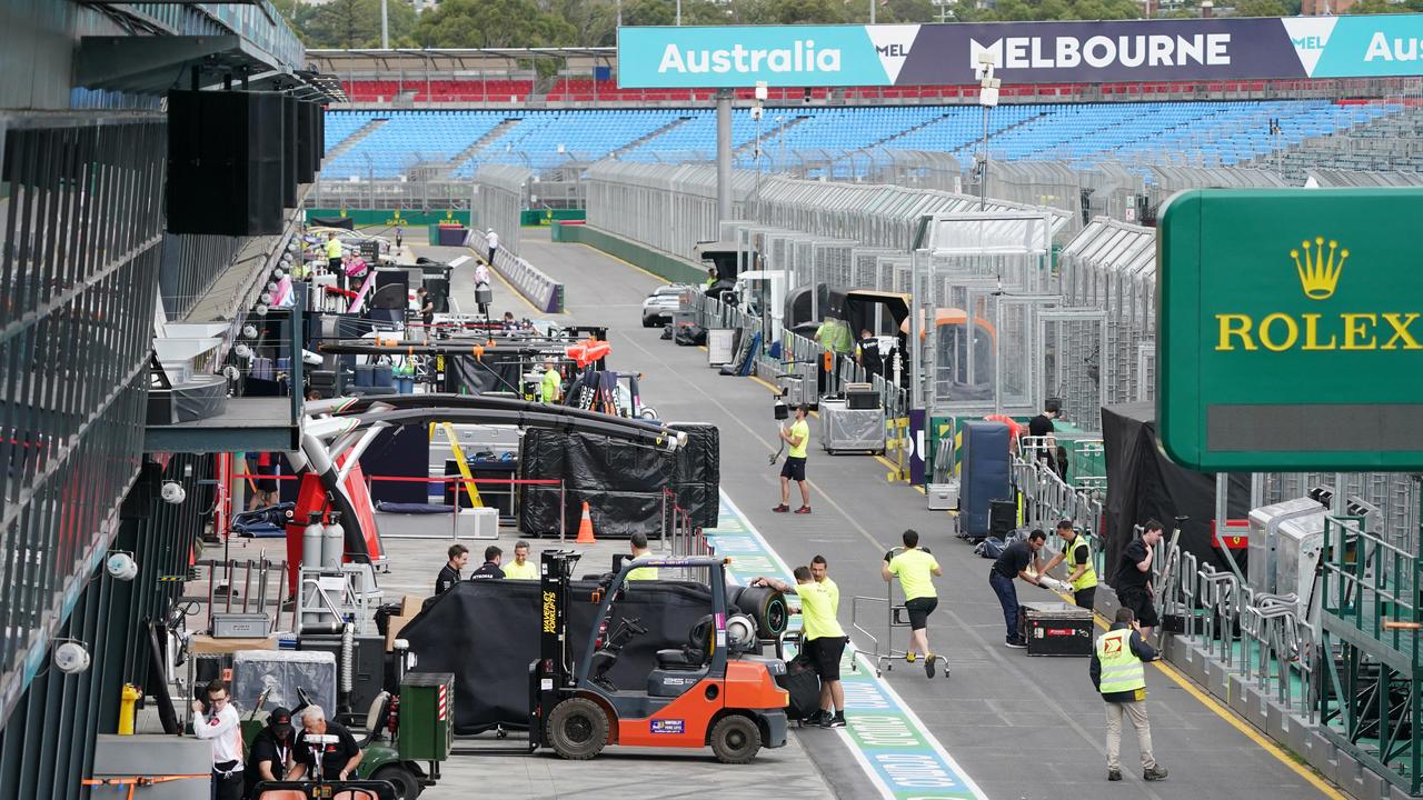 Crews packing up in the pit lane after the 2020 Grand Prix was cancelled. Picture: AAP Image/Michael Dodge