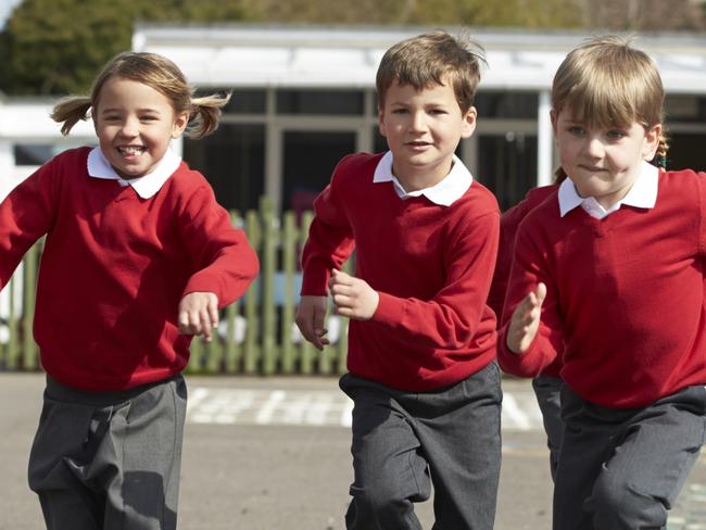 Schools of excellence - Elementary School Pupils Running In Playground Towards Camera