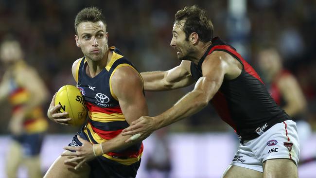 On the run ... Brodie Smith takes on Essendon’s Jobe Watson. Picture: Sarah Reed