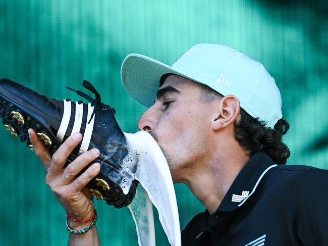 ADELAIDE, AUSTRALIA - FEBRUARY 16: Joaquin Niemann of Torque celebrates with a shoey on stage after winning the  LIV Golf Adelaide at The Grange Golf Club on February 16, 2025 in Adelaide, Australia. (Photo by Mark Brake/Getty Images)