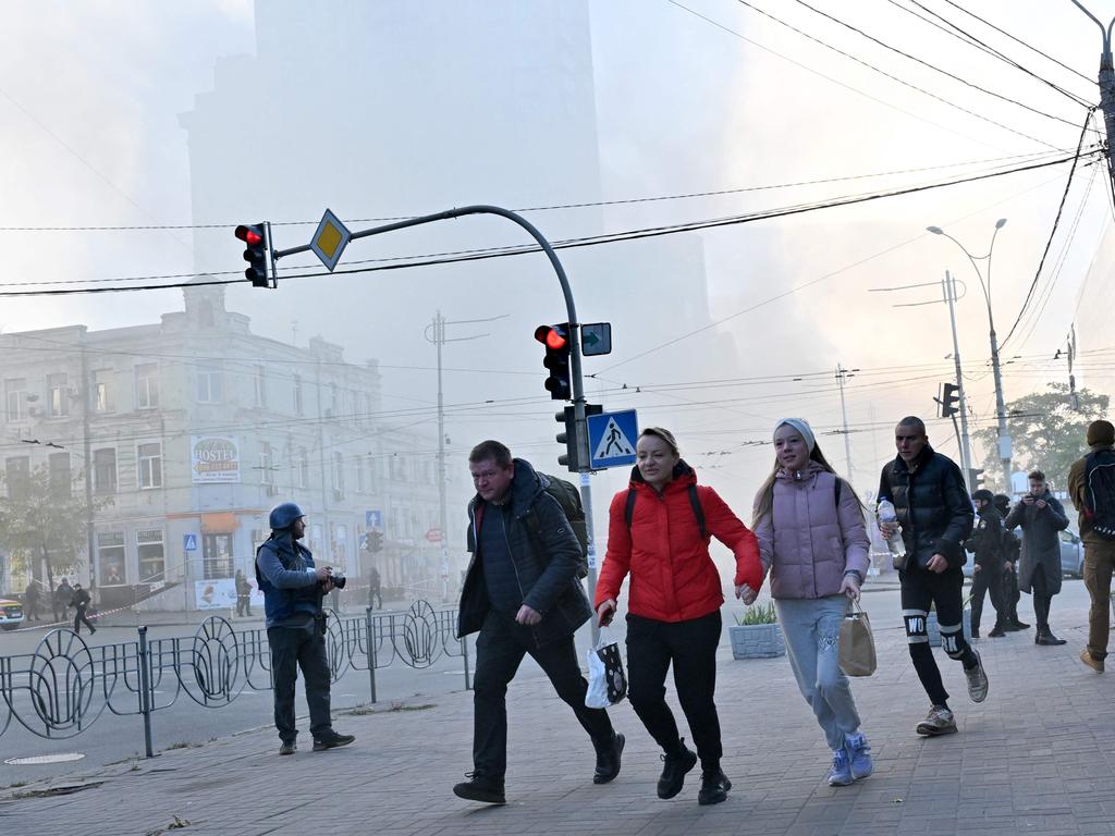 Locals flee after a drone attack in Kyiv that claimed five more lives on Monday.