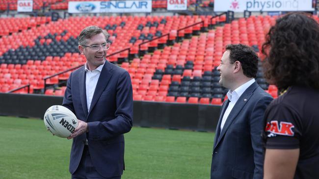 NSW Premier, Dominic Perrottet announces funding for a new stadium at Penrith. Perrottet (left) discusses the new stadium with Stuart Ayres (centre) and Penrith Player Jerome Luai (right). Picture: NCA NewsWire / David Swift