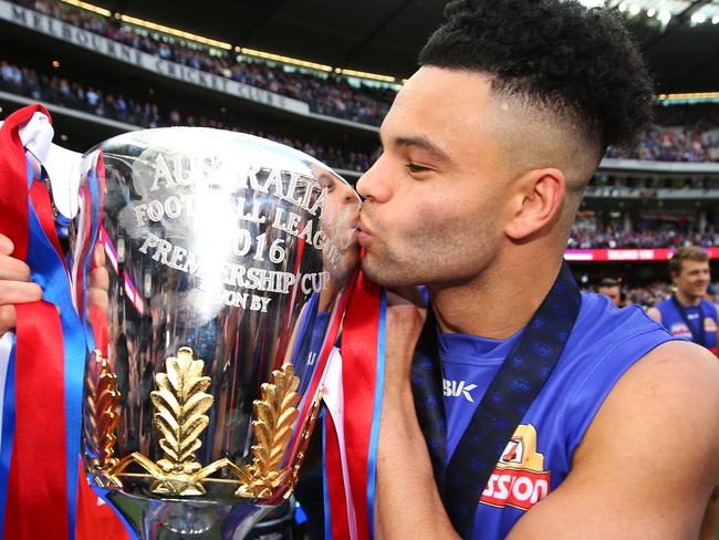 MELBOURNE, VICTORIA - OCTOBER 01: Norm Smith medallist Jason Johannisen of the Bulldogs kisses the premiership cup during the 2016 AFL Grand Final match between the Sydney Swans and the Western Bulldogs at Melbourne Cricket Ground on October 1, 2016 in Melbourne, Australia. (Photo by Michael Dodge/AFL Media/Getty Images)