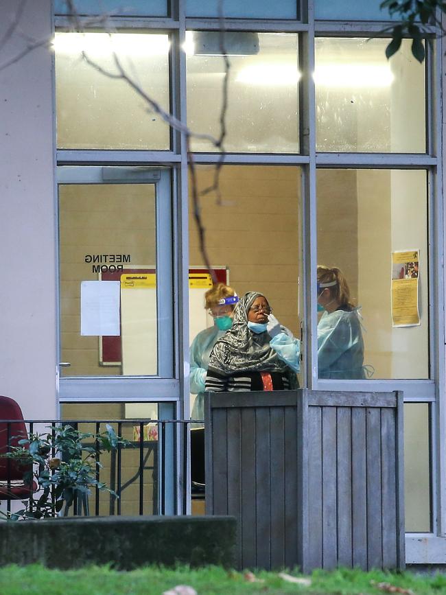 A resident is tested for the virus inside the public housing estate. Picture: Ian Currie