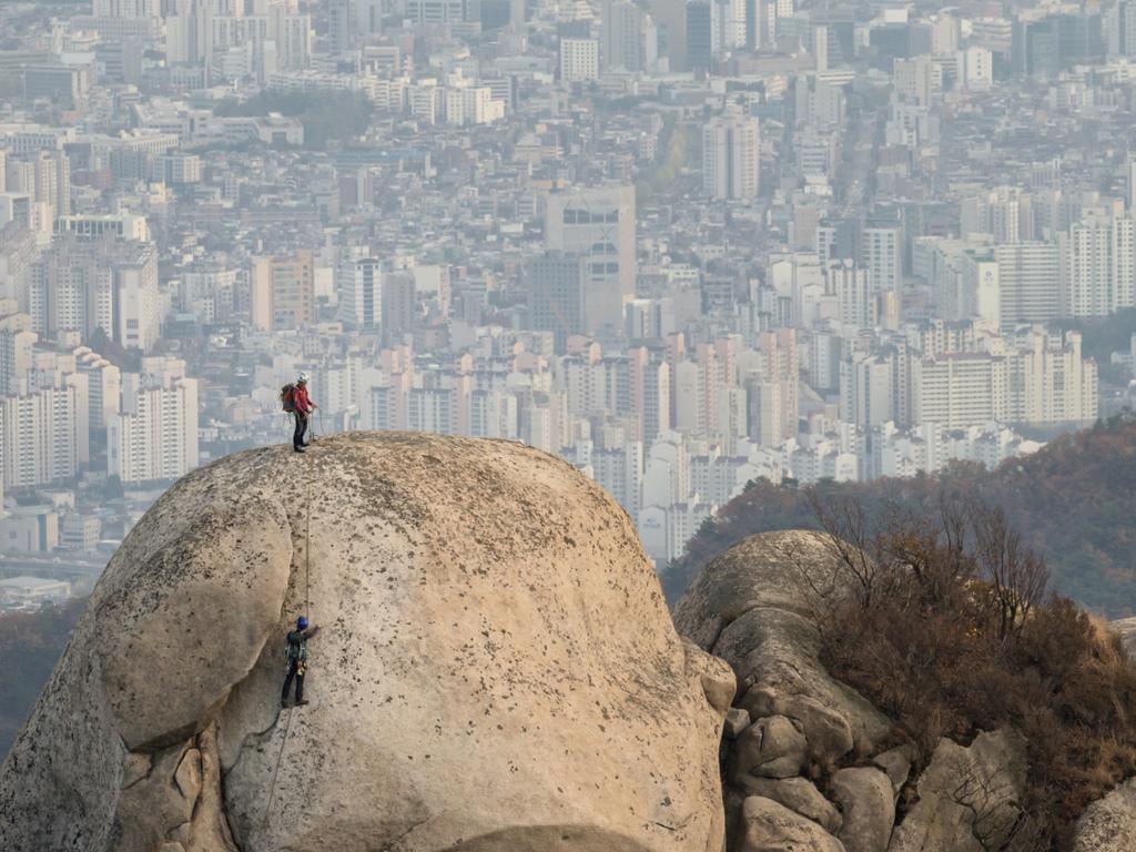 Rock climbers can be seen from Bukhansan's Peak outside of Seoul, South Korea. The size of the South Korean megacity is hard to imagine without visiting. Picture: Brian Hammonds/National Geographic Photo Contest