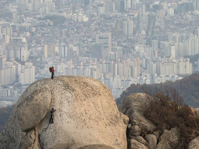 Rock climbers can be seen from Bukhansan's Peak outside of Seoul, South Korea. The size of the South Korean megacity is hard to imagine without visiting. Picture: Brian Hammonds/National Geographic Photo Contest