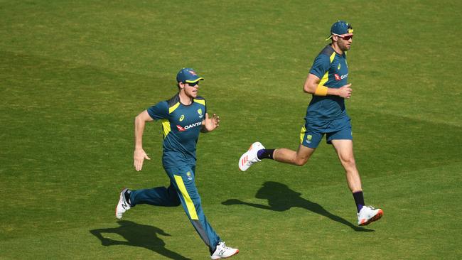 Steve Smith (left) and Andrew Tye warm up before a net session at Emirates Old Trafford. Picture: Gareth Copley/Getty Images for ECB