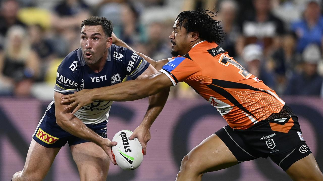Reece Robson of the Cowboys is tackled by Sione Fainu of the Tigers during the round 13 NRL match between North Queensland Cowboys and Wests Tigers at Queensland Country Bank Stadium on May 31, 2025, in Townsville, Australia. (Photo by Ian Hitchcock/Getty Images)